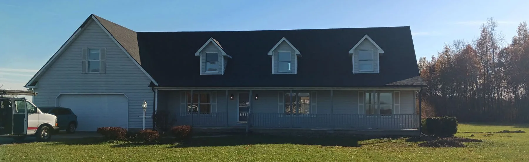 Large two story home with 3 dormers and a brand new roof installed by a local roofing contractor.