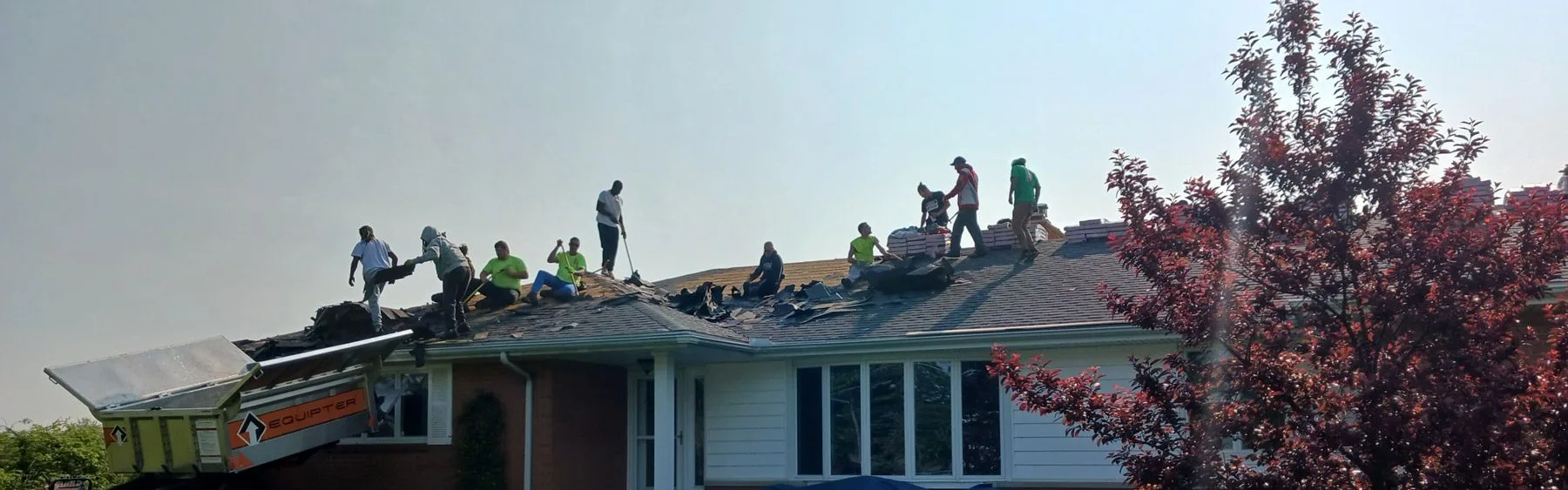 Anderson Roofing's crew work on repairs to a roof in Fremont, Ohio